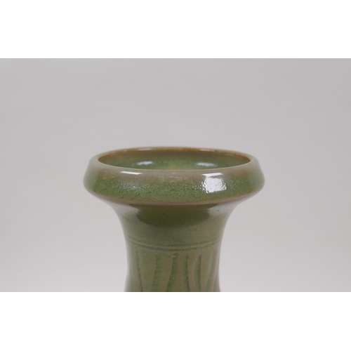 95 - A Chinese olive green glazed porcelain vase with underglaze scrolling floral decoration, 23cm high