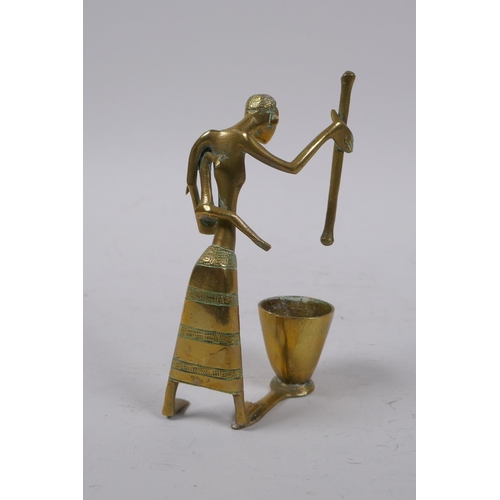 11 - An African Benin style brass figure of a mother carrying a child and using a pestle and mortar, 13cm... 