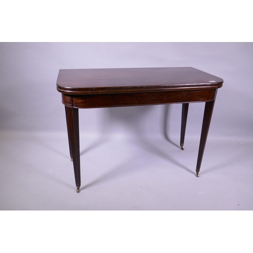 1156 - A Georgian mahogany D shaped tea table, raised on tapering reeded supports with brass castors, 102 x... 