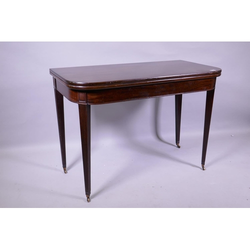 1156 - A Georgian mahogany D shaped tea table, raised on tapering reeded supports with brass castors, 102 x... 