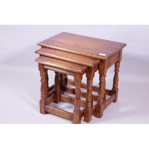 1157 - A nest of three Bevan Funnell oak occasional tables, raised on turned supports, 55 x 36 x 49cm