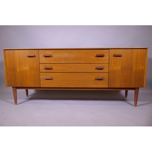 1158 - A mid century E Gomme, G Plan teak dressing table with two cupboards flanking three drawers, 162 x 4... 