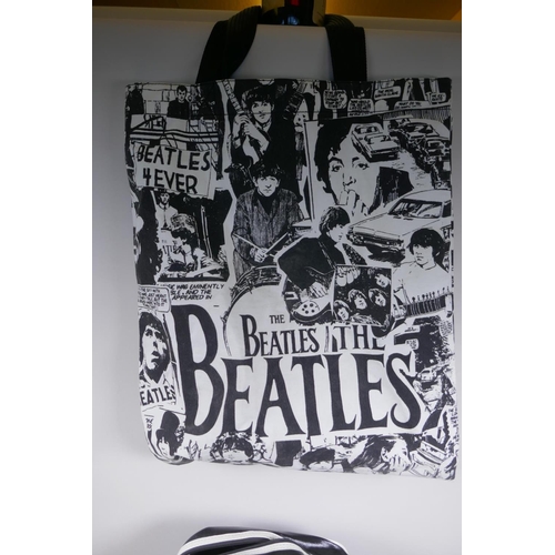 2 - A quantity of Beatles memorabilia including two bags, three Apple Corps caps, Eight Day a Week DVD, ... 