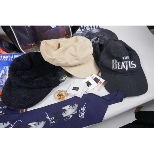 2 - A quantity of Beatles memorabilia including two bags, three Apple Corps caps, Eight Day a Week DVD, ... 