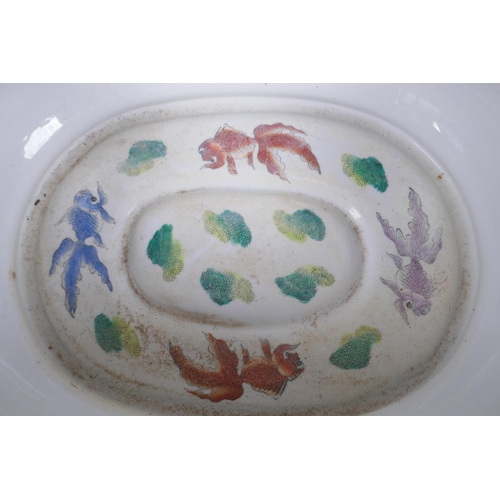 21 - A Chinese porcelain foot bath painted with flowers, butterflies and fish in bright enamels, 43cm wid... 