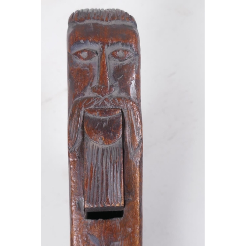 37 - Antique treen nutcrackers with carved decoration of bearded gentlemen, incised R.H. 1761, 28cm long