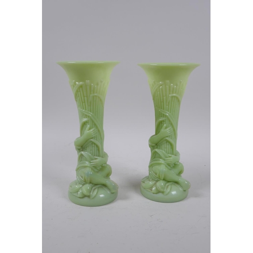 41 - A pair of early C20th Art Nouveau milk glass spill vases in the form of a figure carrying bamboo, 20... 