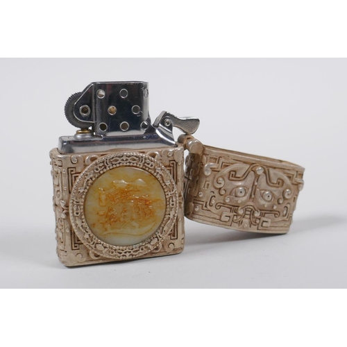 45 - A Chinese white metal cased Zorro lighter with a jade setting depicting a dragon, 6cm high