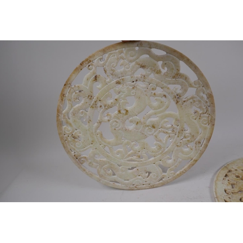 56 - A late C19th/early C20th Chinese carved and pierced celadon hardstone pi-disc with archaic dragon de... 