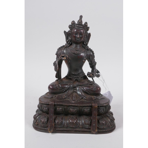 61 - A Sino Tibetan bronze of Buddha seated on a lotus throne, 19cm high