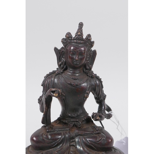 61 - A Sino Tibetan bronze of Buddha seated on a lotus throne, 19cm high