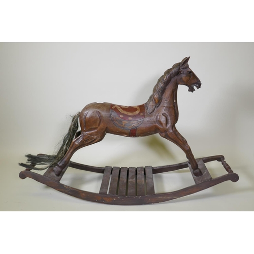 10 - A vintage carved and painted wood rocking horse on a sleigh base, 123cm long