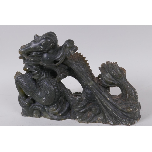 14 - A Chinese carved soapstone figure of a fire breathing dragon, 16cm high