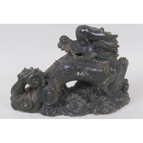 14 - A Chinese carved soapstone figure of a fire breathing dragon, 16cm high