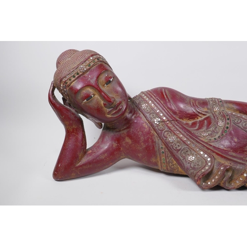 16 - An antique Burmese carved and lacquered wood reclining figure of Buddha, 78cm long