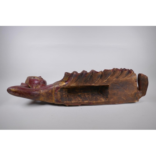 16 - An antique Burmese carved and lacquered wood reclining figure of Buddha, 78cm long