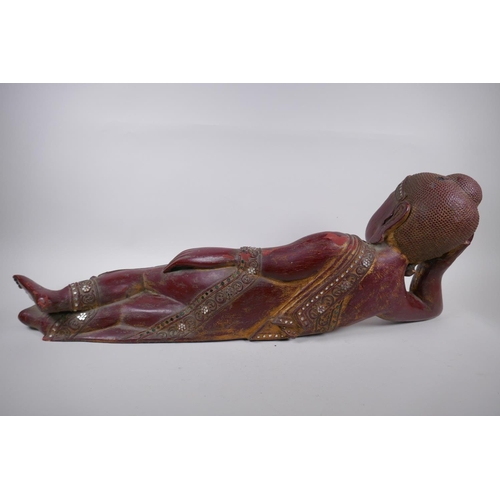 16 - An antique Burmese carved and lacquered wood reclining figure of Buddha, 78cm long