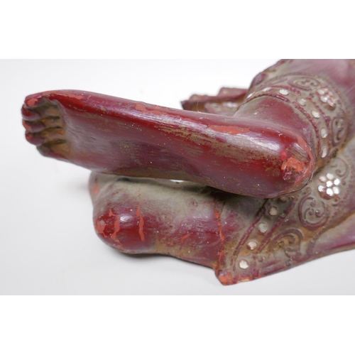 16 - An antique Burmese carved and lacquered wood reclining figure of Buddha, 78cm long