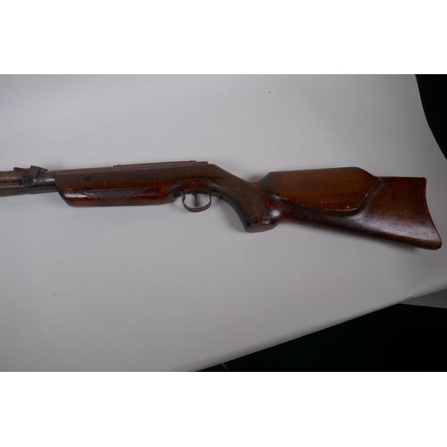 17 - A vintage air rifle with carved wood stock, 112cm long, AF