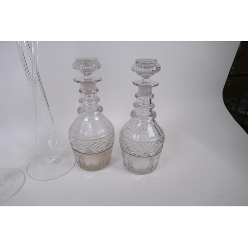 18 - A pair of Georgian three ring neck decanters with star cut decoration, 27cm high, and a near pair of... 