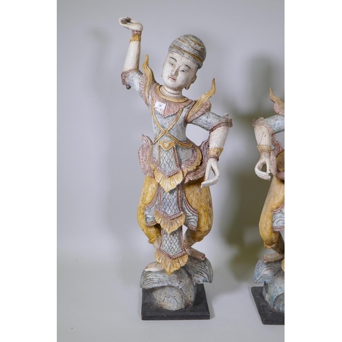 20 - A pair of Indian carved and painted hardwood figures of dancers, 117cm high