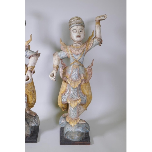 20 - A pair of Indian carved and painted hardwood figures of dancers, 117cm high