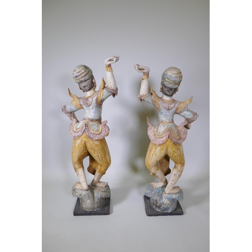 20 - A pair of Indian carved and painted hardwood figures of dancers, 117cm high