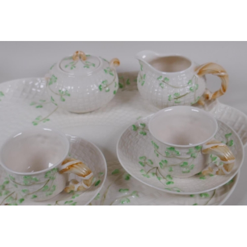 22 - A Belleek style Shamrock pattern china cabaret set with green harp and crown back stamp, sucrier AF,... 