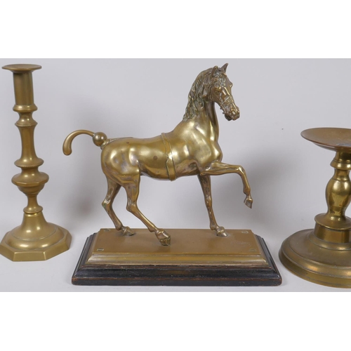 26 - A well cast brass figure of a horse with the remains of silver plate, a pair of brass candlesticks, ... 