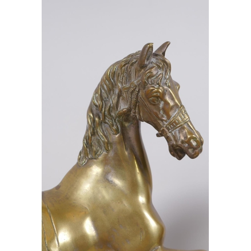 26 - A well cast brass figure of a horse with the remains of silver plate, a pair of brass candlesticks, ... 