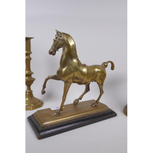 26 - A well cast brass figure of a horse with the remains of silver plate, a pair of brass candlesticks, ... 