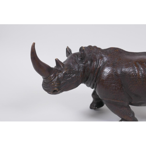 28 - A filled bronze rhinoceros, 23cm long