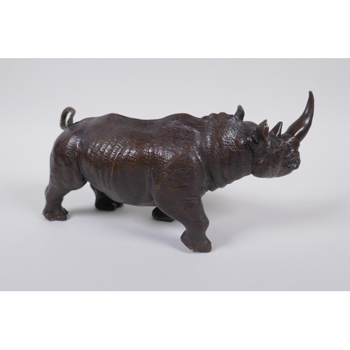 28 - A filled bronze rhinoceros, 23cm long