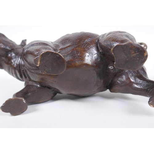 28 - A filled bronze rhinoceros, 23cm long