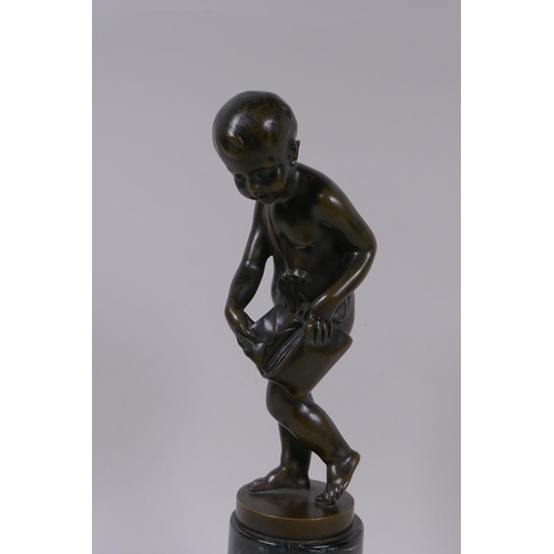 3 - A bronze figure of Cupid delivering love letters,  raised on a turned marble socle, 28cm high