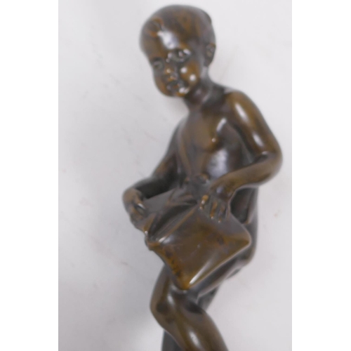 3 - A bronze figure of Cupid delivering love letters,  raised on a turned marble socle, 28cm high