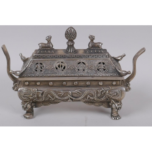 34 - A Chinese sarcophagus shaped cast white metal censer and cover, with raised dragon decoration, 20cm ... 