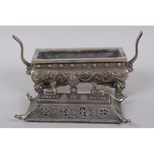 34 - A Chinese sarcophagus shaped cast white metal censer and cover, with raised dragon decoration, 20cm ... 