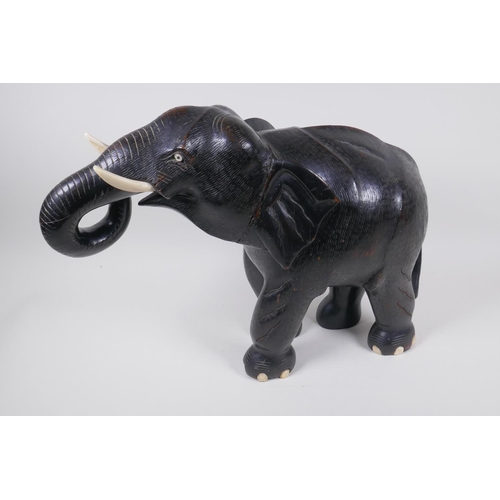 52 - A carved wood African elephant with bone tusks, 34cm high