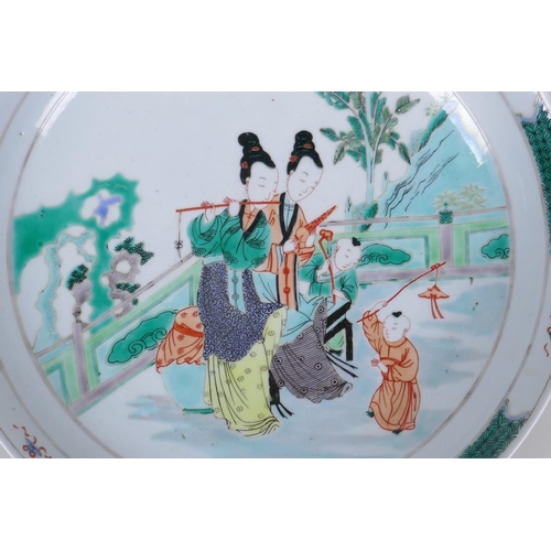 55 - A famille verte porcelain charger decorated with women and children, Chinese Kangxi 6 character mark... 