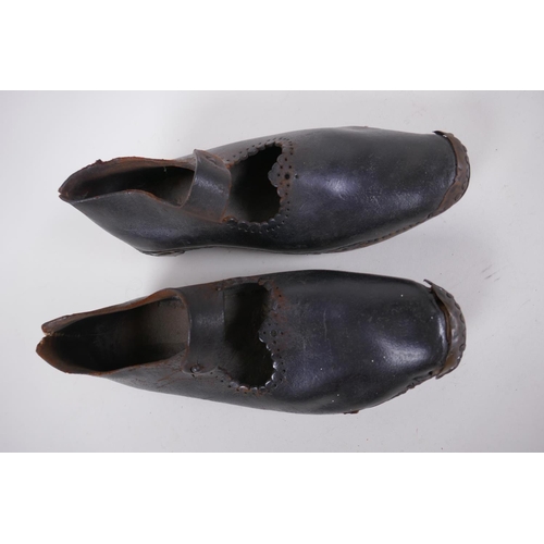 59 - A pair of antique leather and wood dancing clogs, 26cm long