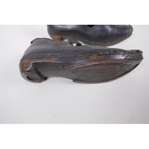 59 - A pair of antique leather and wood dancing clogs, 26cm long