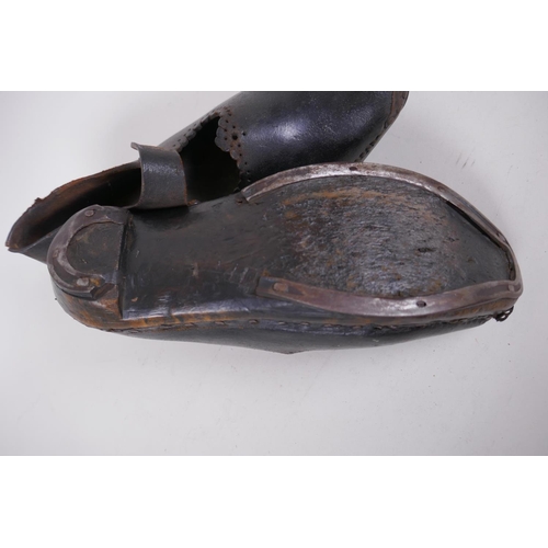 59 - A pair of antique leather and wood dancing clogs, 26cm long