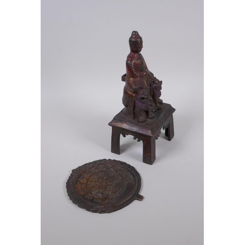 60 - A Sino Tibetan bronze Buddha seated upon fo-dogs, with remnants of gilt patina, 29cm high