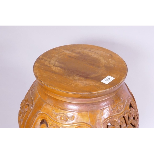 1139 - A Chinese jardiniere stand with carved and pierced details, raised on shaped supports with scroll fe... 