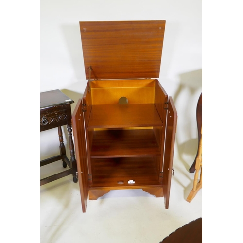 1141 - A yew wood media cabinet on bracket feet, an oak two drawer side table, an oval topped mahogany tabl... 