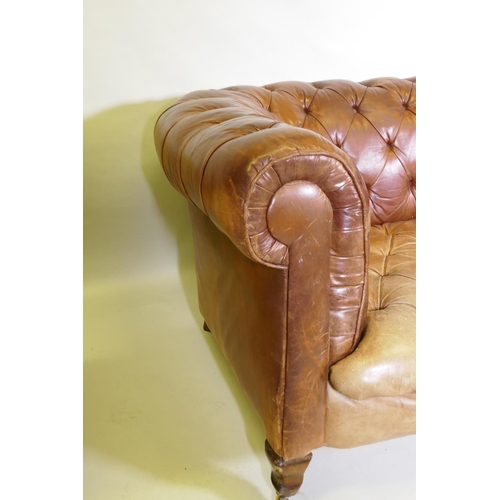 1150 - A leather chesterfield settee, raised on shaped beechwood supports, horse hair stuffed, springs need... 