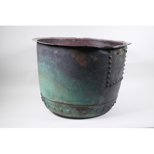 18 - An antique riveted copper bin, with historic repair, 36cm high, 50cm diameter