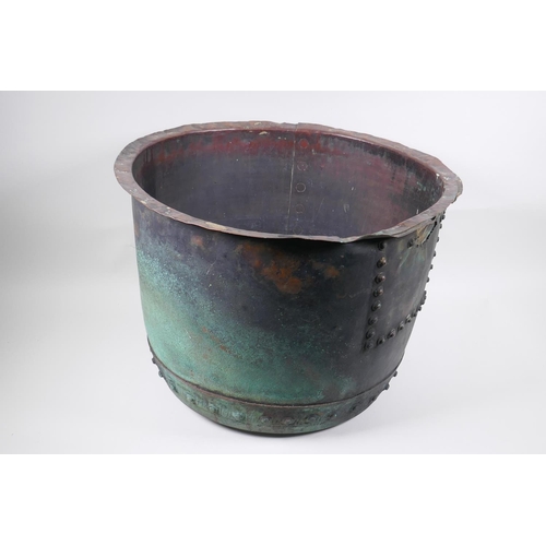 18 - An antique riveted copper bin, with historic repair, 36cm high, 50cm diameter