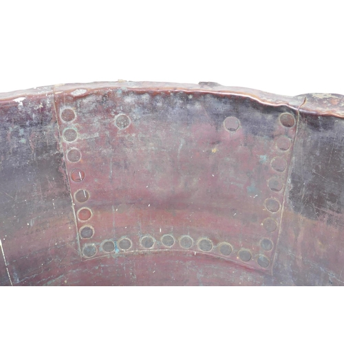 18 - An antique riveted copper bin, with historic repair, 36cm high, 50cm diameter